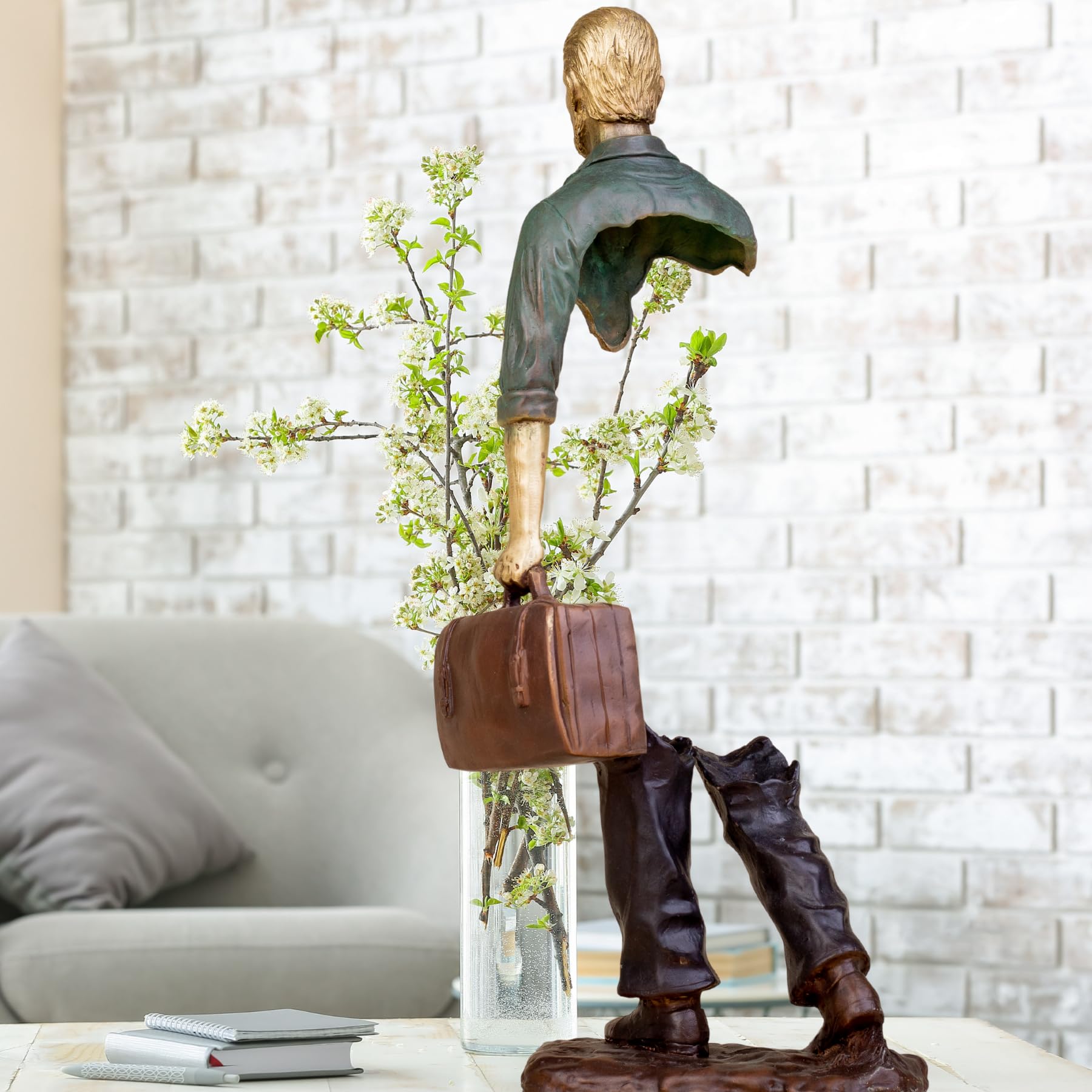 Deep emerald standing voyageur bronze statue as a statement piece for an executive office.