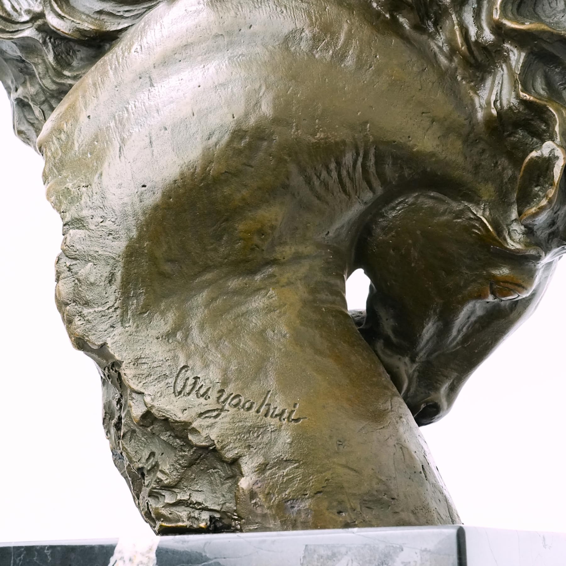 Close-up detail of "Flames of Spirit" bronze horse head sculpture showing artist signature on base