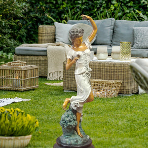 Flora goddess bronze statue on garden terrace beside rattan furniture as luxury outdoor sculpture