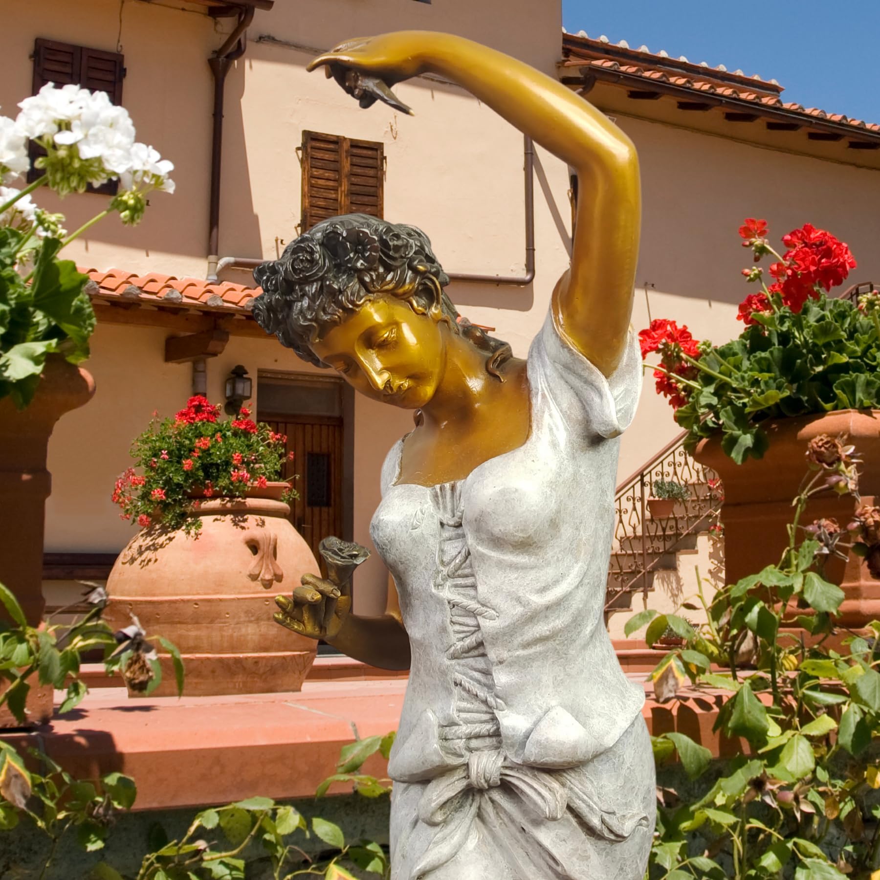 Flora goddess bronze statue displayed in rose garden setting highlighting flower goddess theme and rose accents