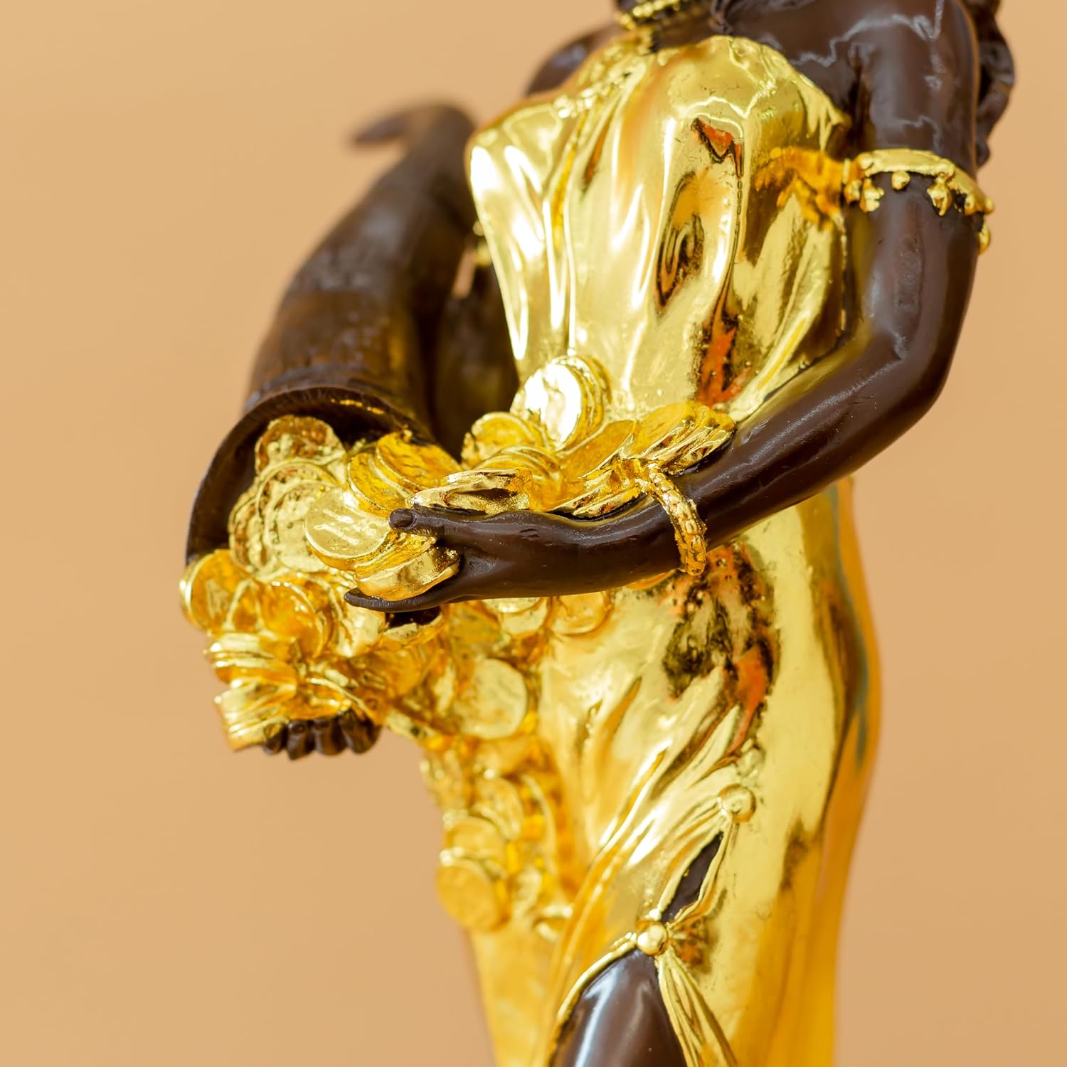 Gilded bronze Fortuna goddess wealth statue cornucopia spilling coins detail close up
