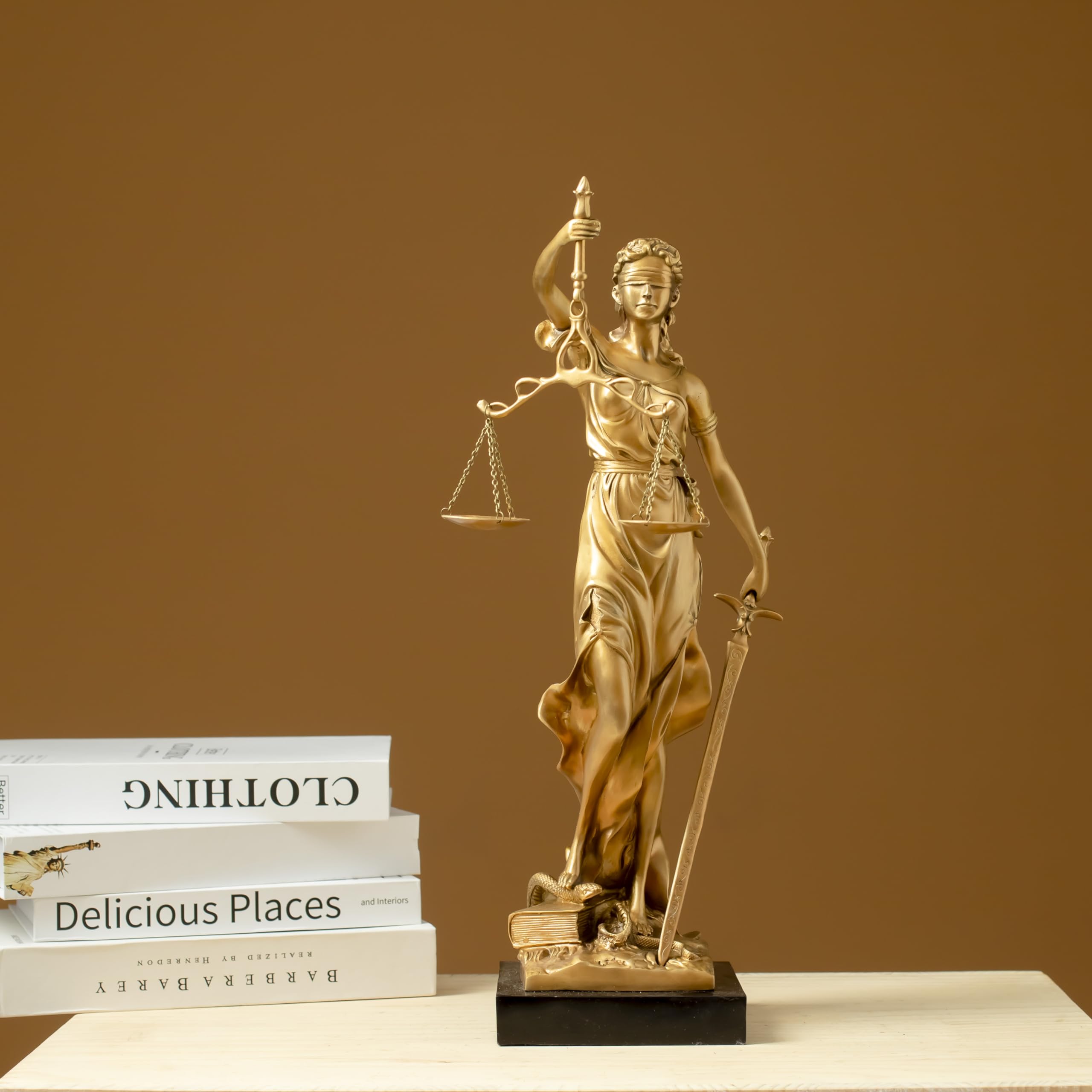 Gold Lady Justice Themis statue displayed with business card holder on professional lawyer desk