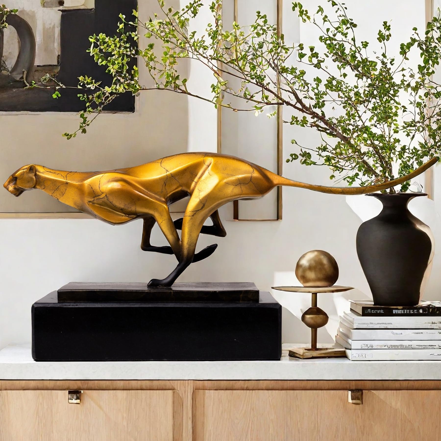 Gold running cheetah sculpture on indoor side table styled with vase in home decor setting