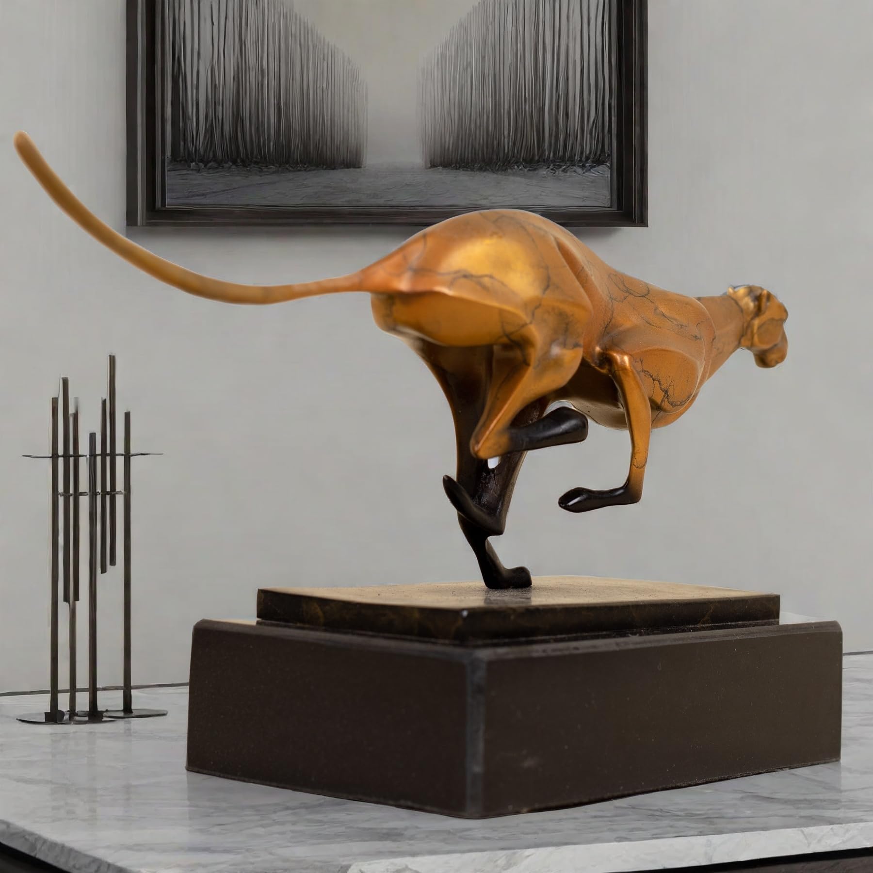 Close-up detail of gold running cheetah sculpture on black marble base in indoor decor