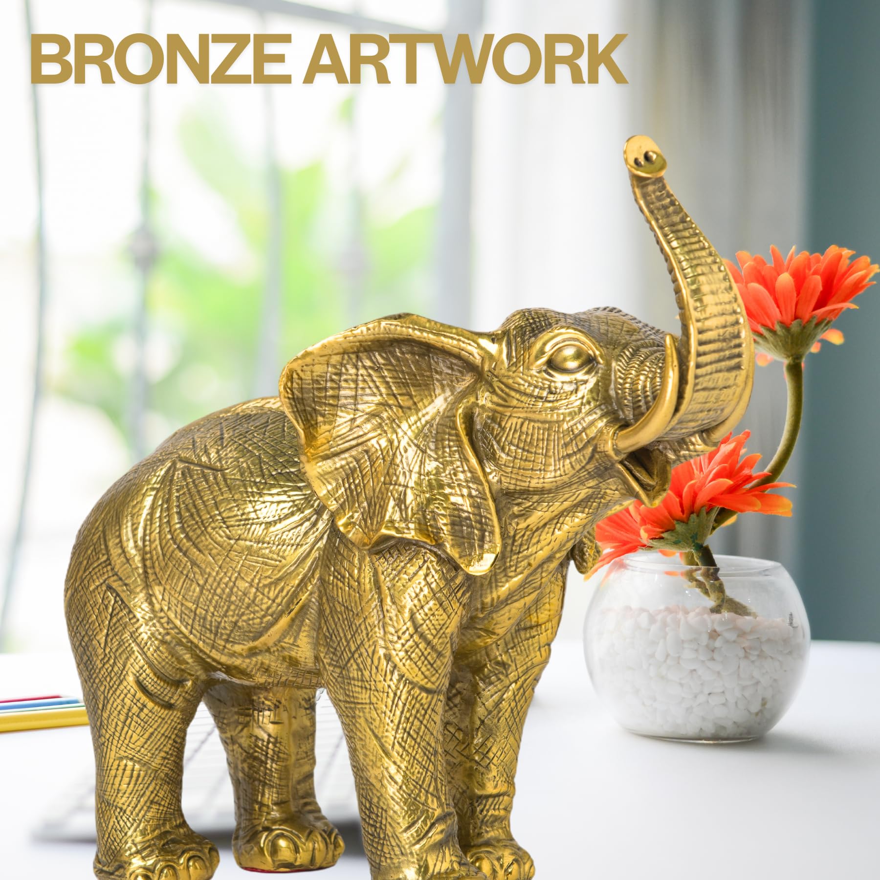 Golden brass elephant statue beside fireplace as majestic luxury home decor accent