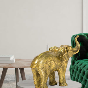 Golden brass elephant statue size reference beside decorative vase showing scale and proportions