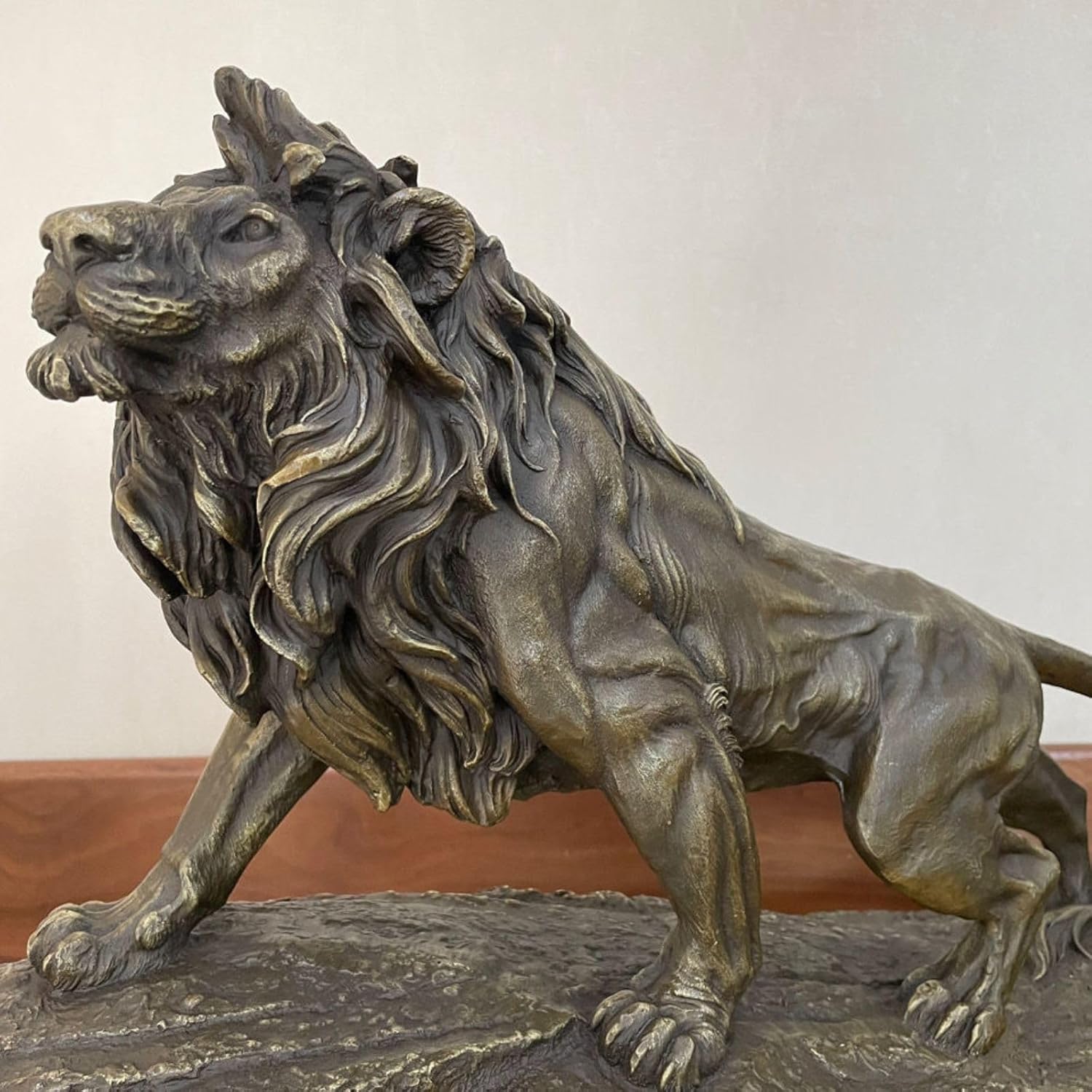 Grand bronze lion statue on marble base displayed on luxury dining table in elegant interior