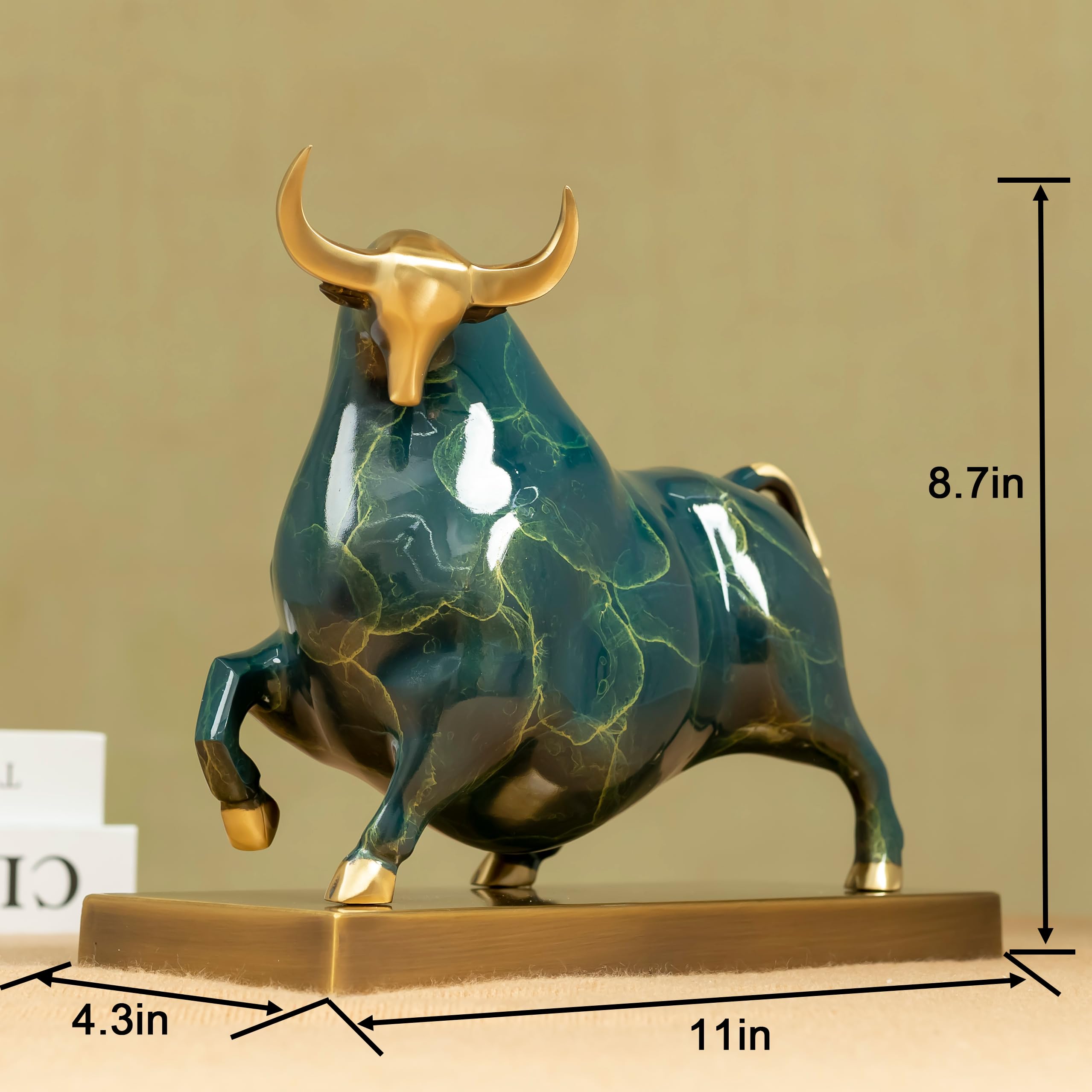 Profile view of the green enamel bull with polished brass base.