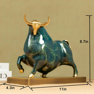 Profile view of the green enamel bull with polished brass base.