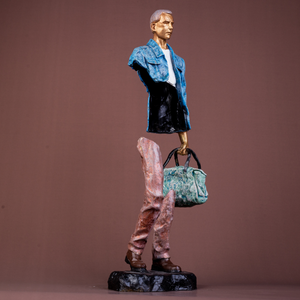 Contemporary hollow bronze statue of a man holding a bag, colorful modern art sculpture