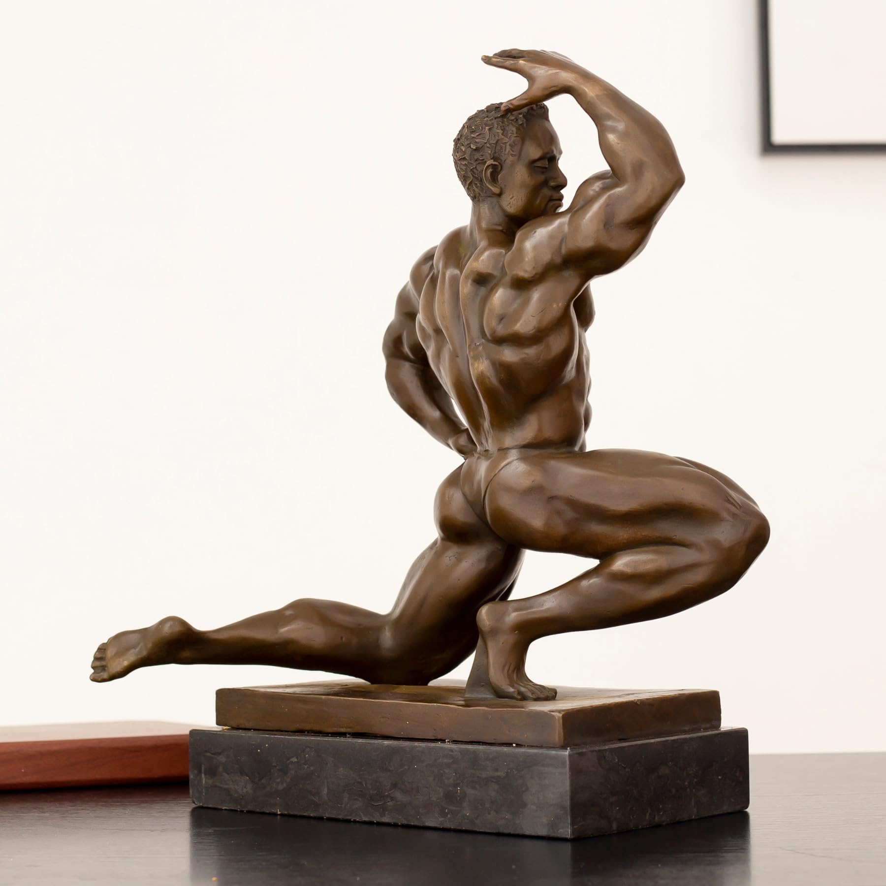 Front pose view of solid hot-cast bronze kneeling bodybuilder sculpture on rectangular marble base