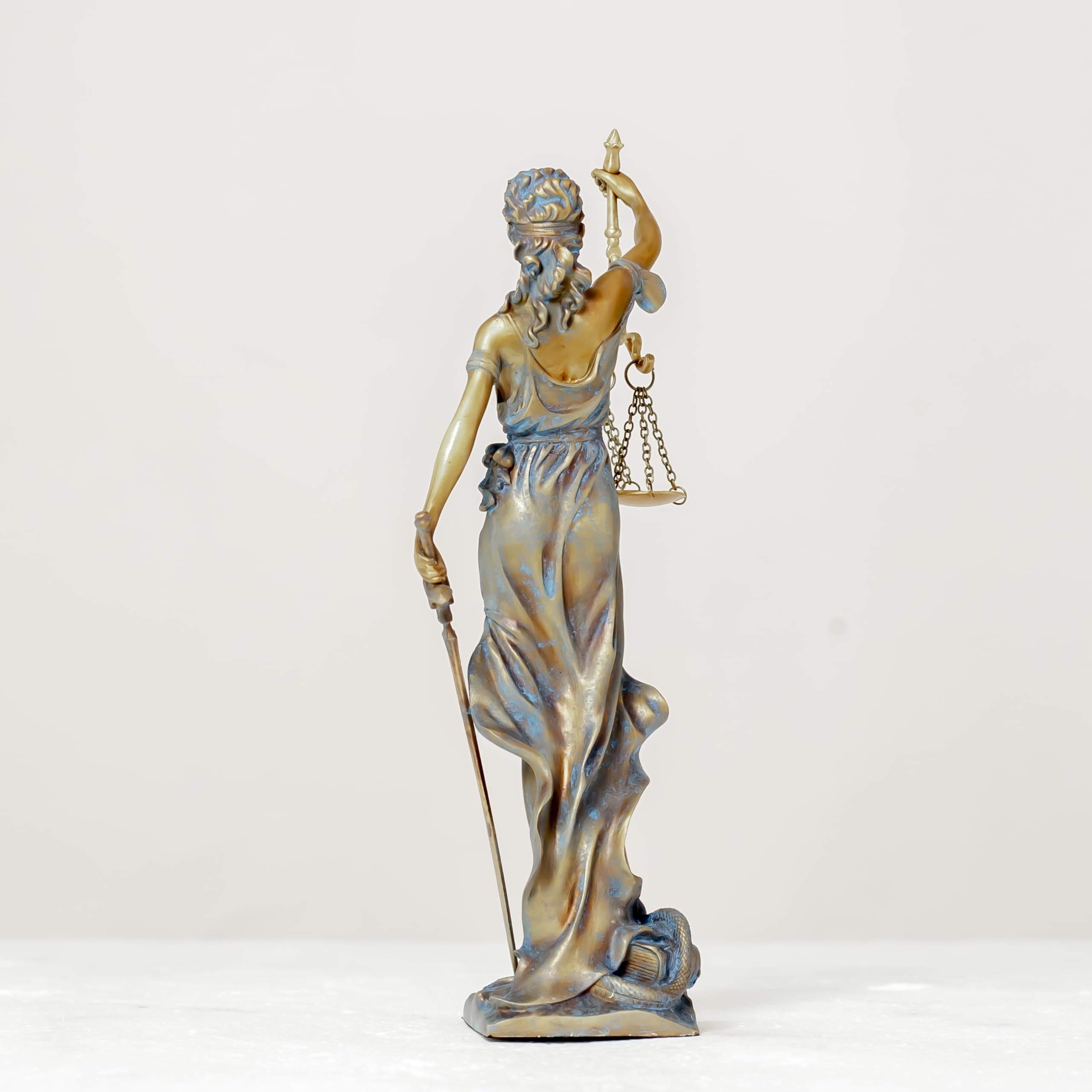 blue Lady Justice Themis statue side ody view on white background showing sword and scale
