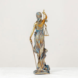 blue Lady Justice Themis statue side ody view on white background showing sword and scale