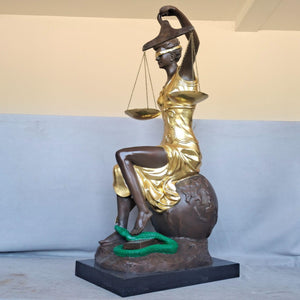 Back angle view of large gold bronze Lady Justice Themis seated handmade sculpture on marble base