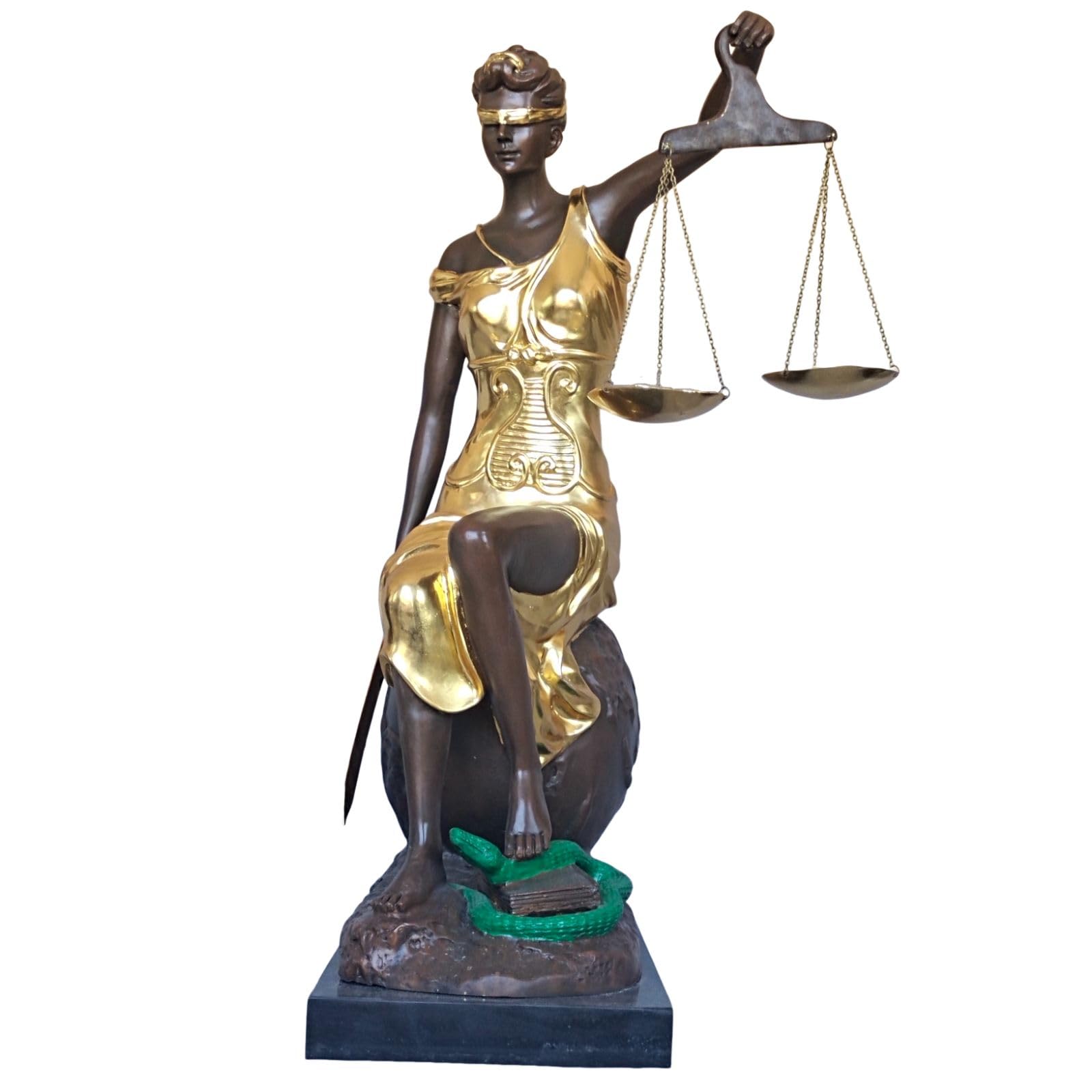 Close-up detail of large gold bronze Lady Justice Themis statue showing gilded finish and scale texture