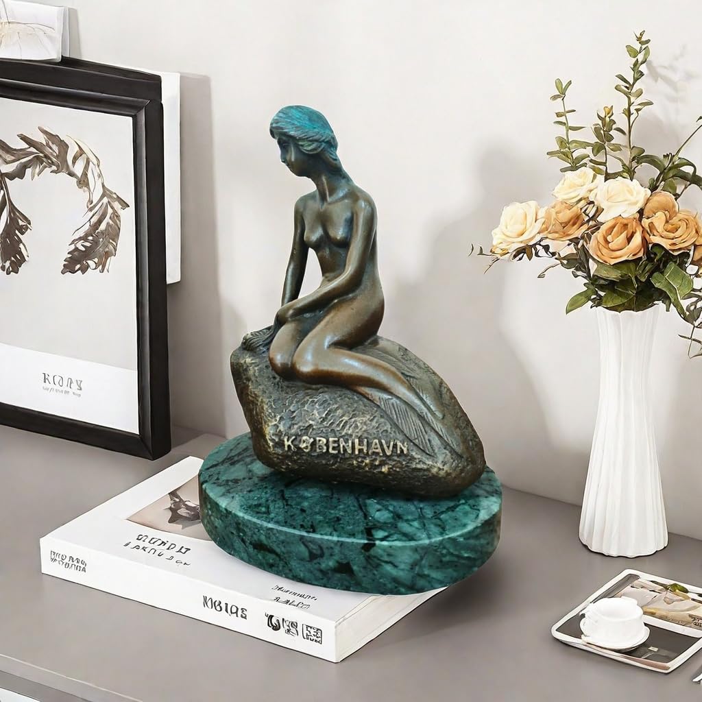 Little mermaid bronze sculpture on side table beside yellow flowers bright interior