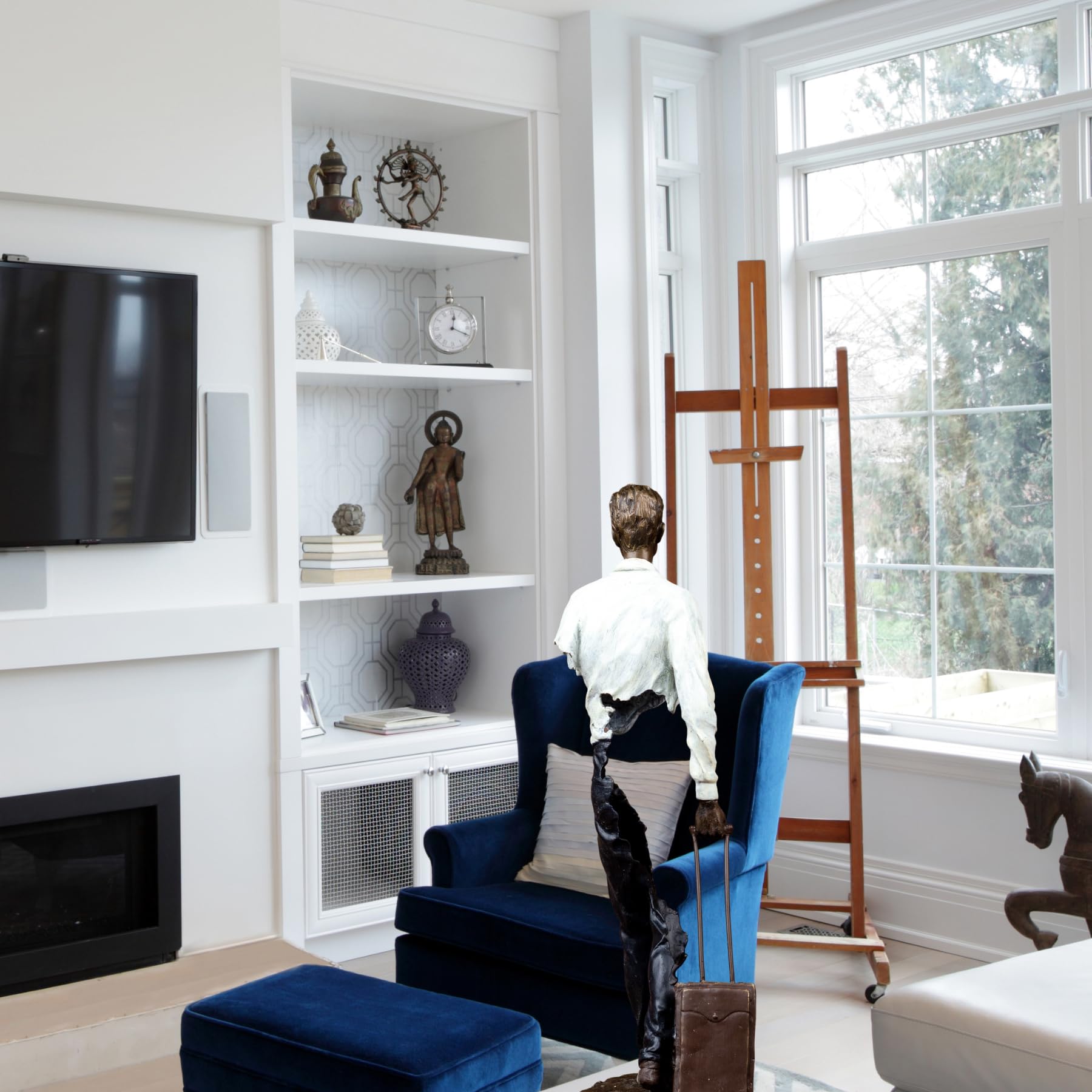 The Les Voyageurs bronze sculpture styled as a luxury interior statement piece in a modern room.