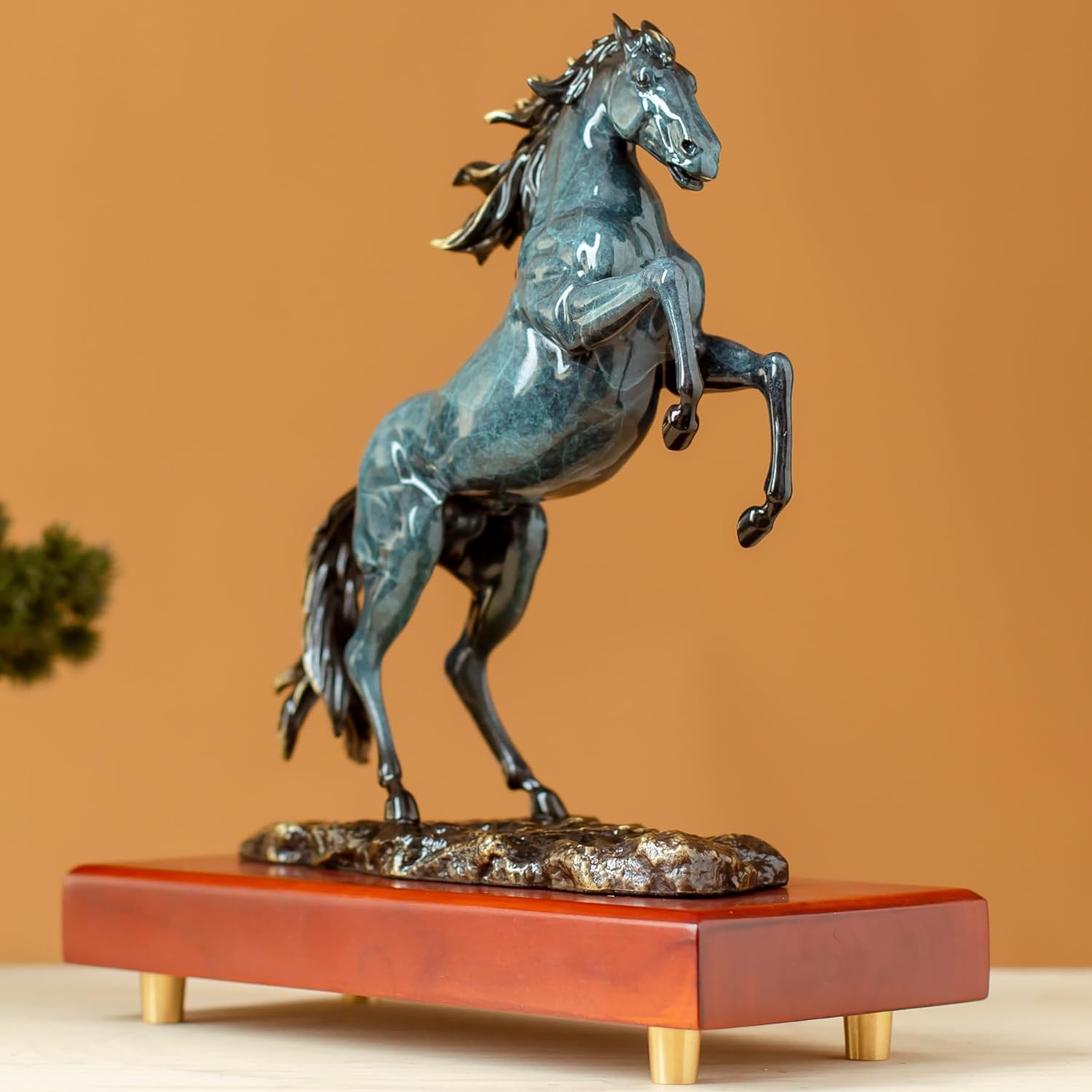 Azure blue rearing horse bronze sculpture front angle view on premium wood base with warm background