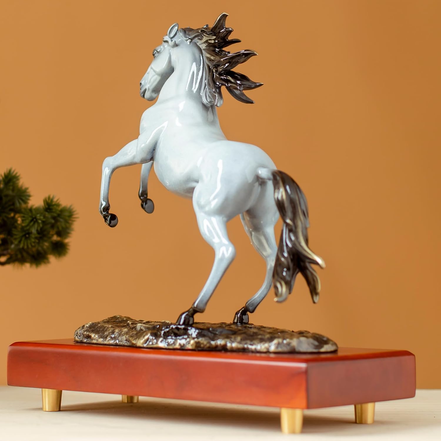 Pearl white rearing horse bronze sculpture back angle view showing flowing tail