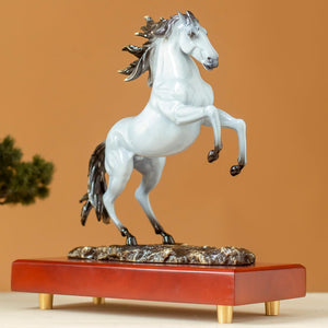 Pearl white rearing horse bronze sculpture side view on wood base with warm background