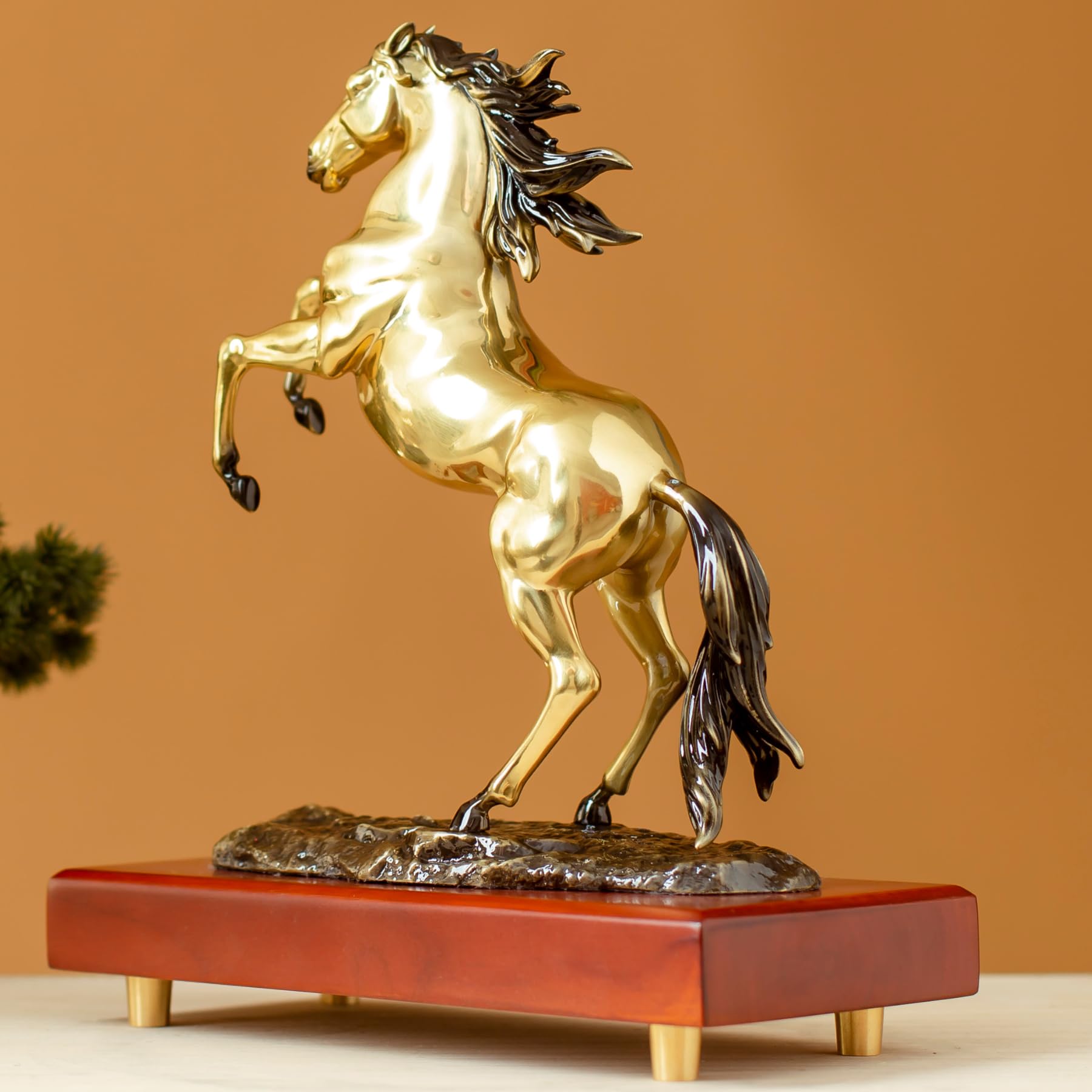 Radiant gold rearing horse bronze sculpture back angle view showing flowing mane and tail