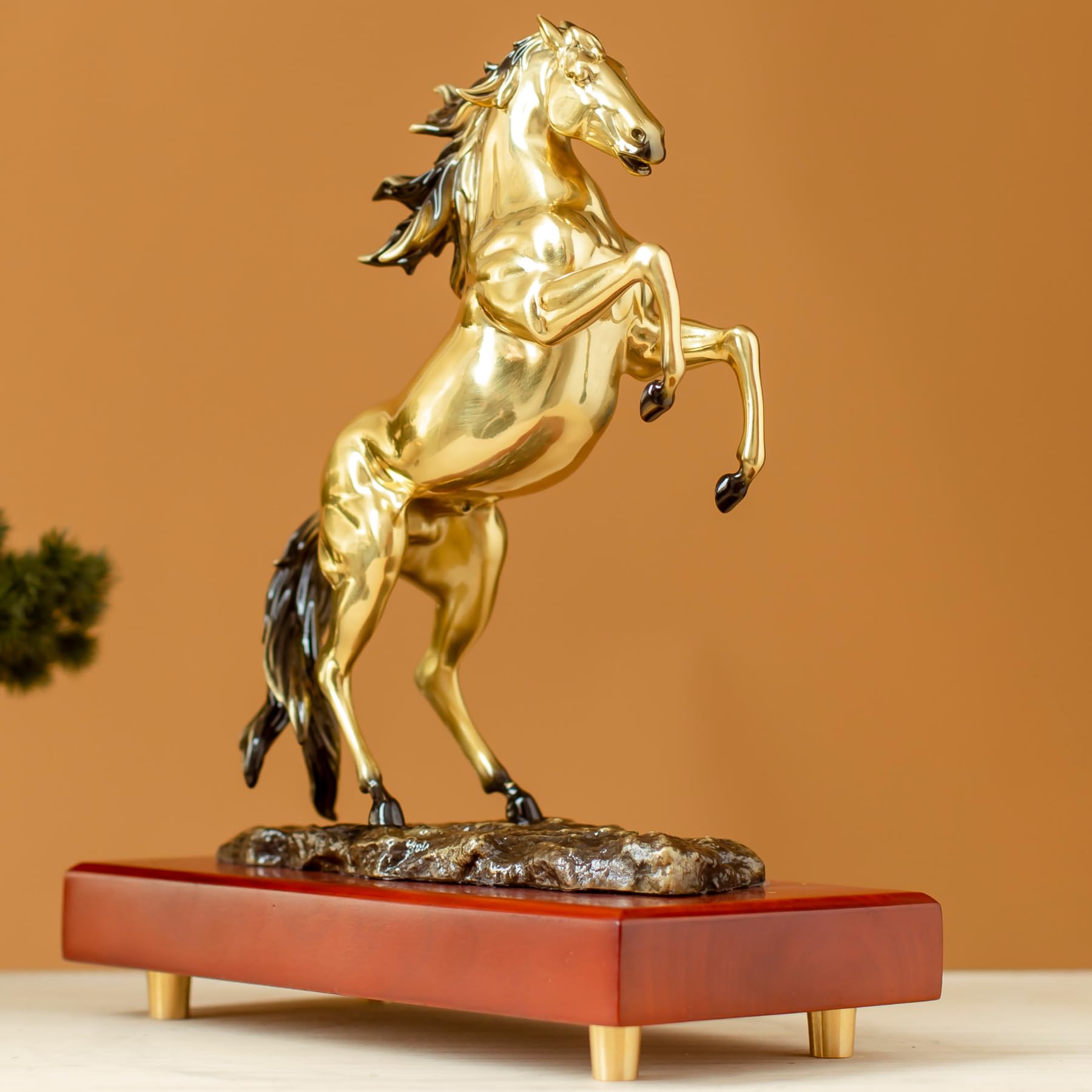 Radiant gold rearing horse bronze sculpture front angle view on wood base