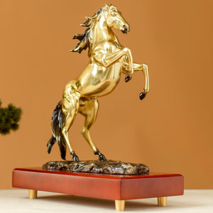 Radiant gold rearing horse bronze sculpture front angle view on wood base