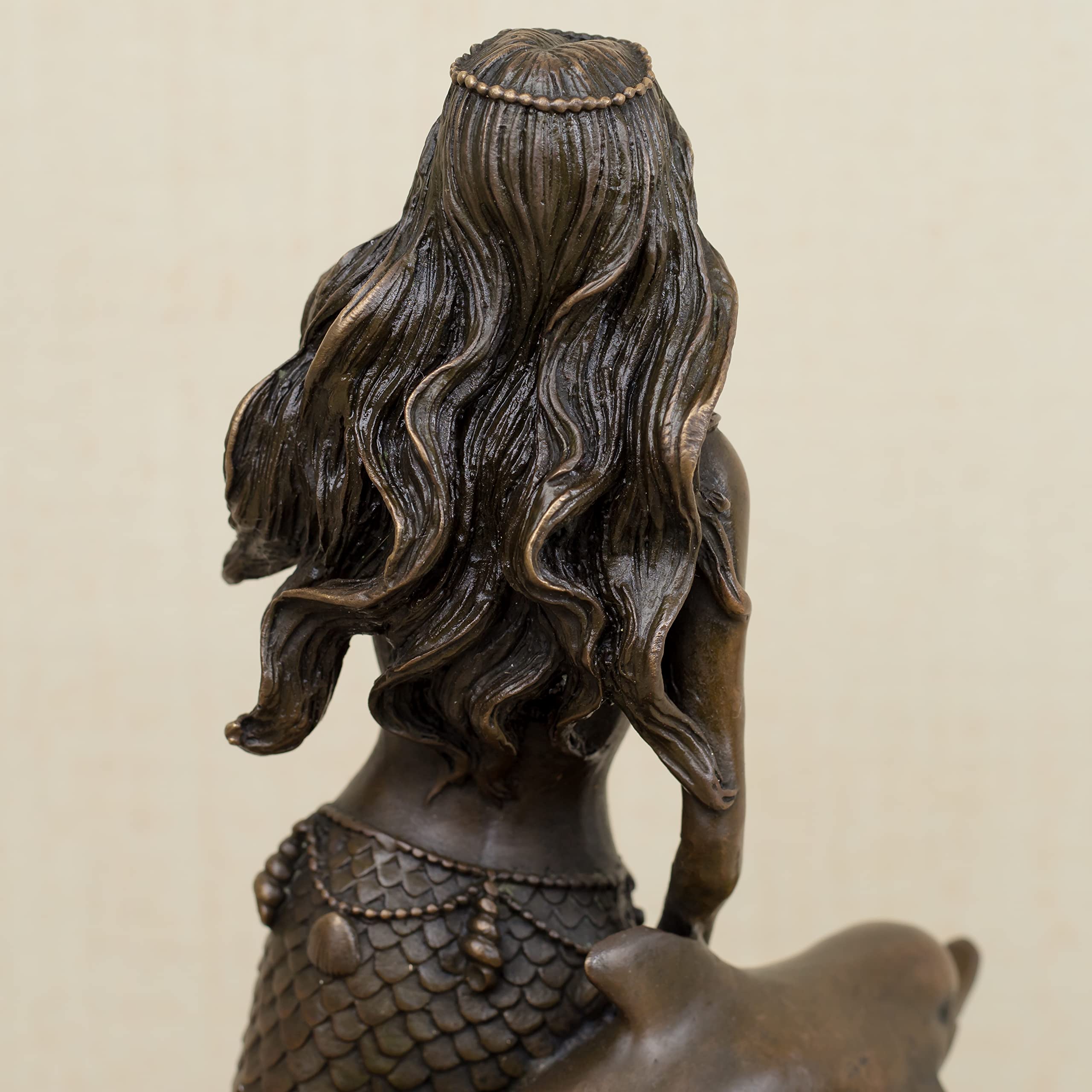 Mermaid and dolphin bronze sculpture hair and face detail close up dark patina