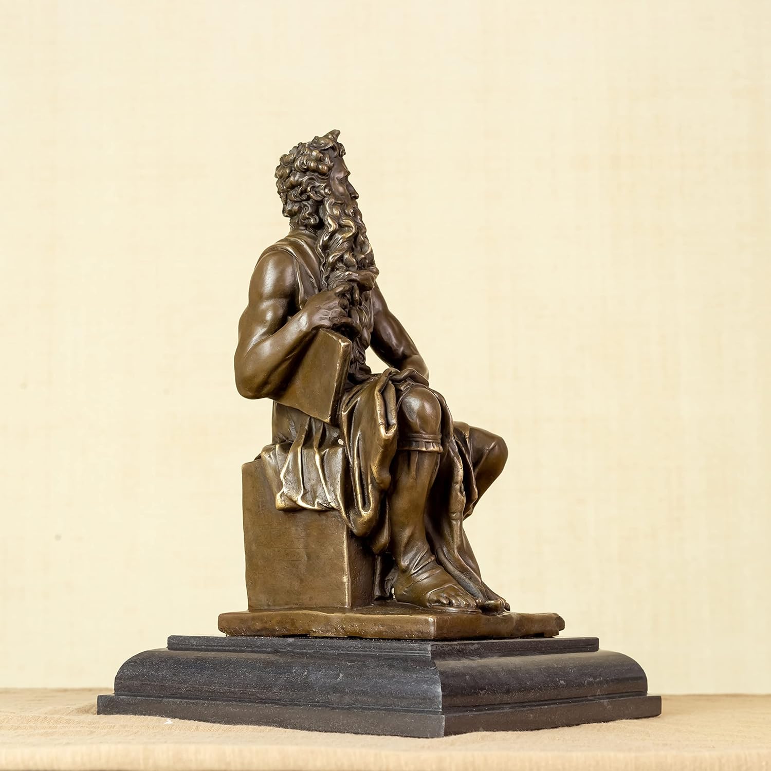 Moses bronze replica statue left side angle showing sculpted details and dark stone base