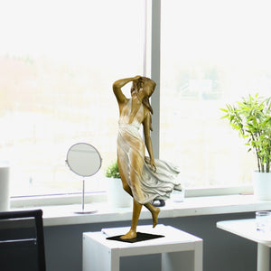 Neoclassical bronze wind dancer gold dress in bright modern living room