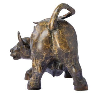 A macro, highly detailed close-up portrait shot of the unique artistic patterned patina on a solid bronze Wall Street charging bull statue, highlighting the intricate gold and brown mottled texture and lost-wax casting details.