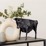Minimalist black bull statue in a contemporary home interior.