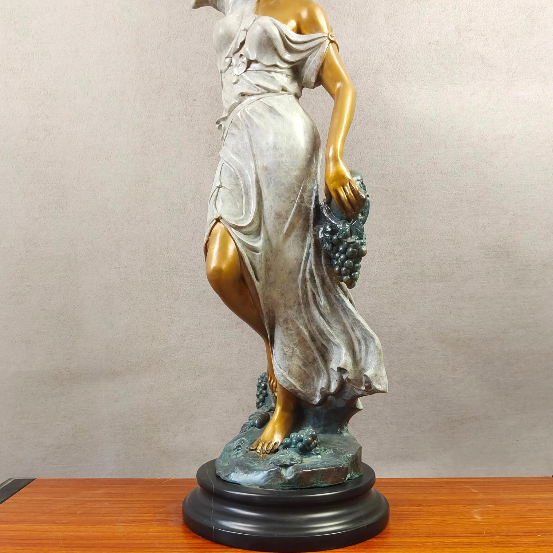 Pomona goddess bronze statue right side view on white background displaying grape vine details and marble base