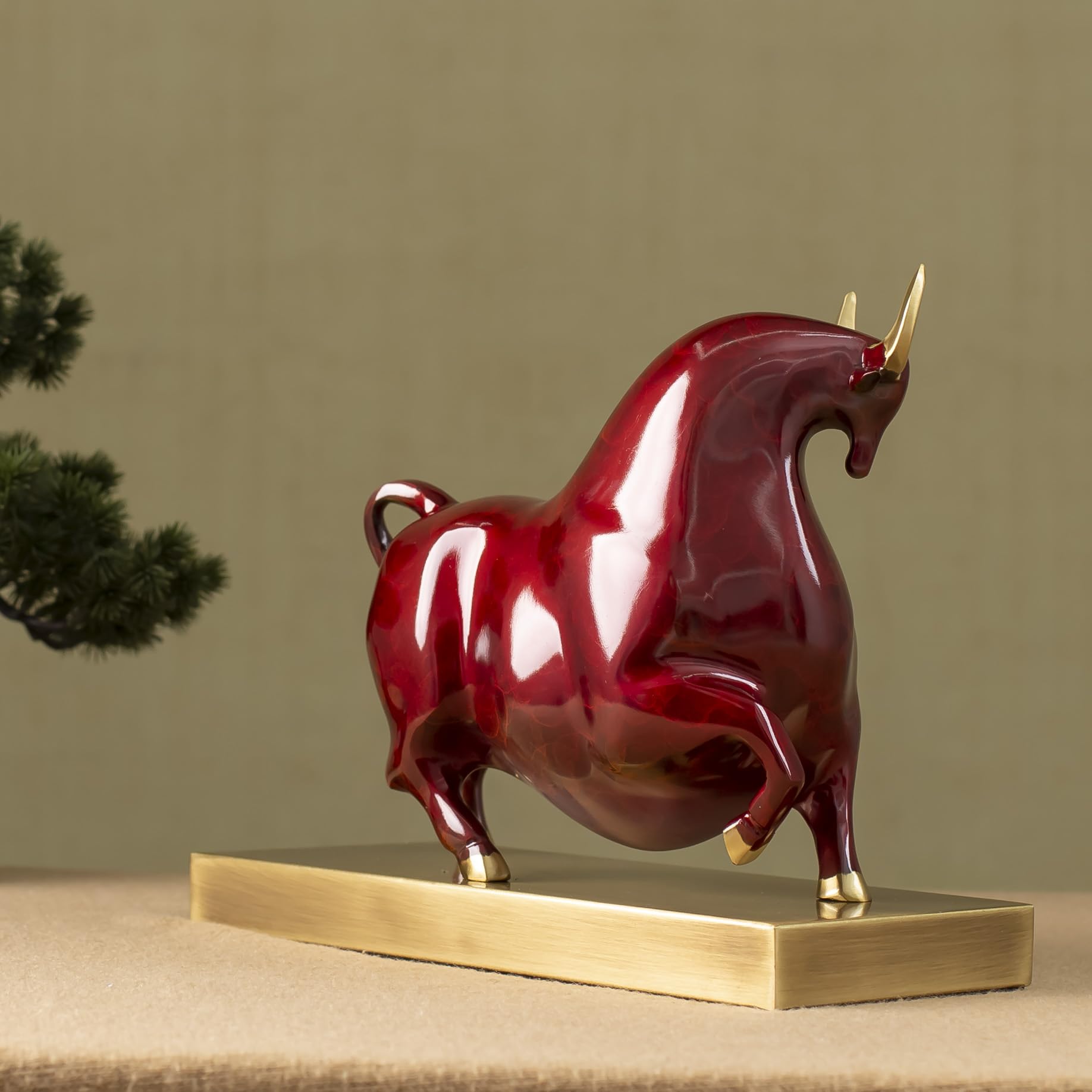 Solid brass base detail of the luxury red enamel bull.