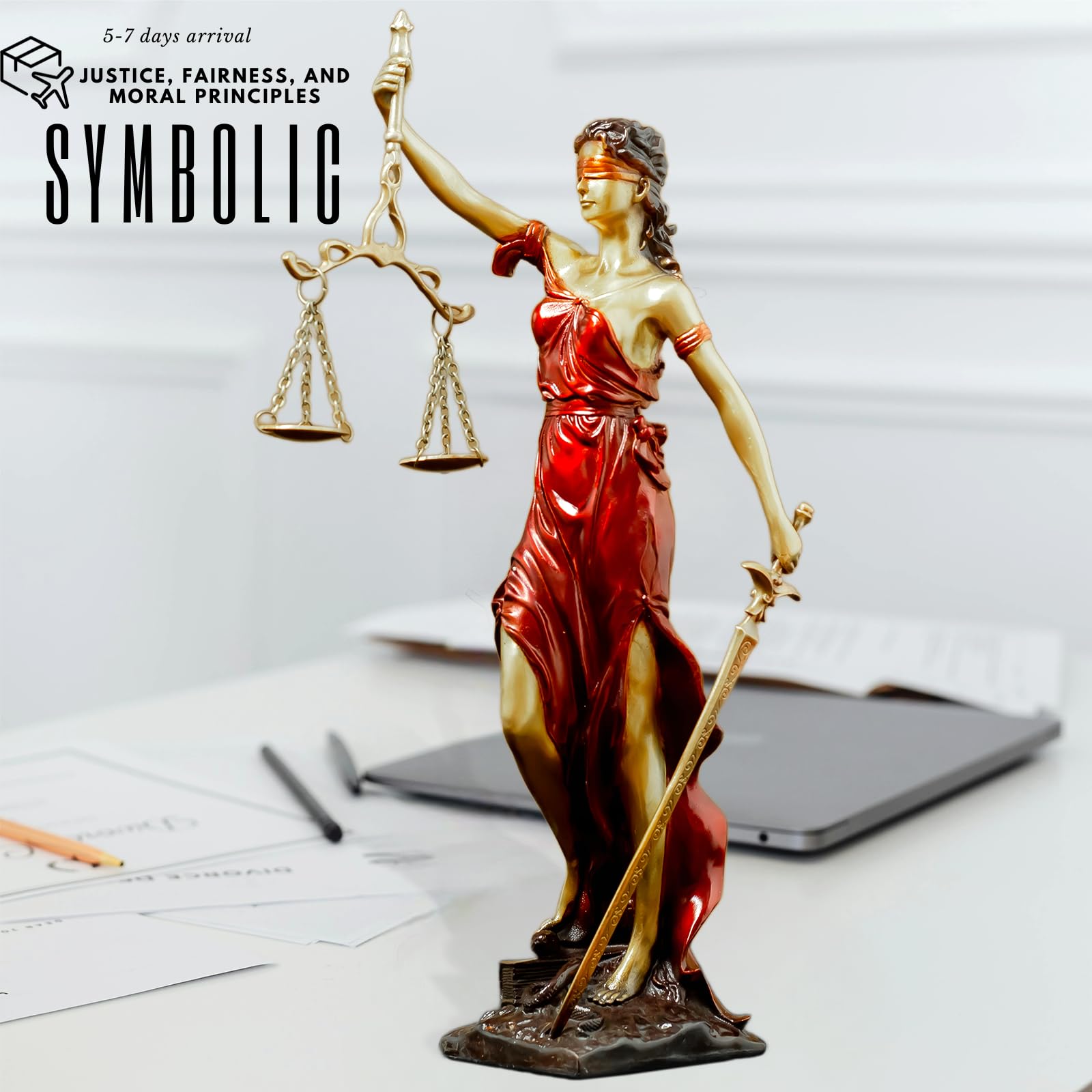 Red Lady Justice Themis statue as symbolic legal decor on modern desk alongside laptop display