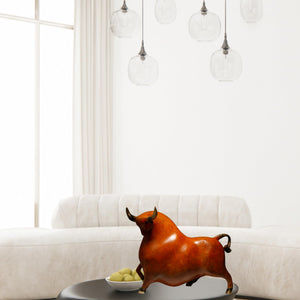 Reddish-orange bull art figurine for home and office decor.