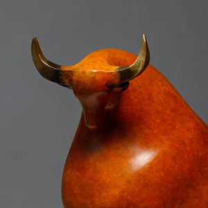 Close-up of abstract bull head with brass horn details.