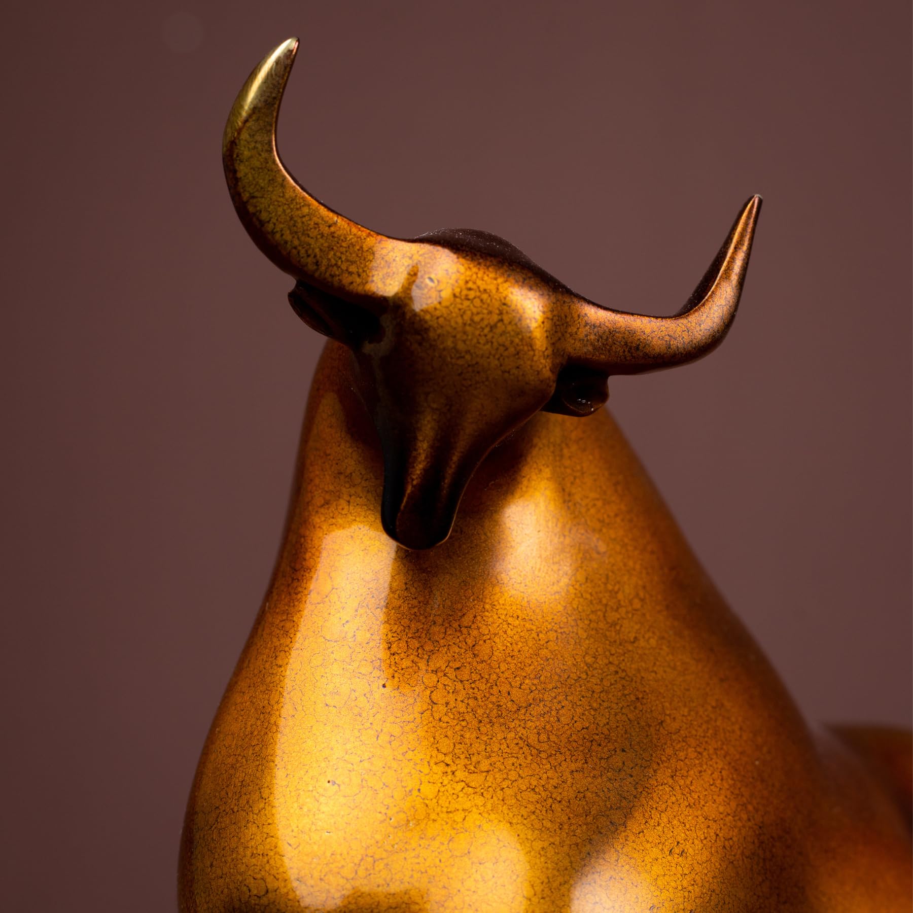 Close-up of abstract bull head with brass horn details.
