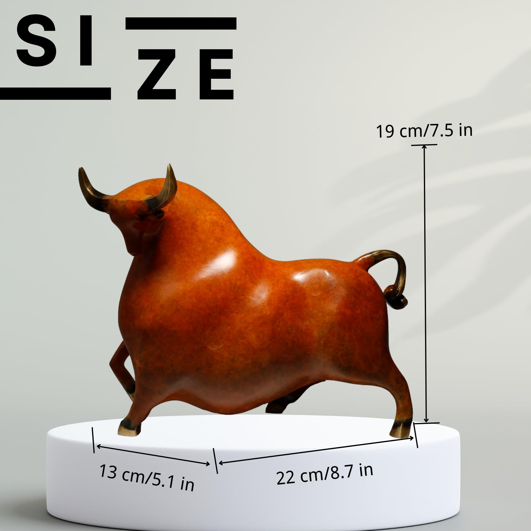 Profile view of the reddish-orange charging bull figurine.