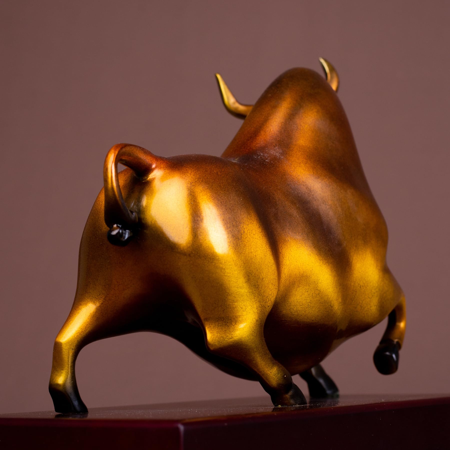 Elegant reddish-orange charging bull for home office decoration.