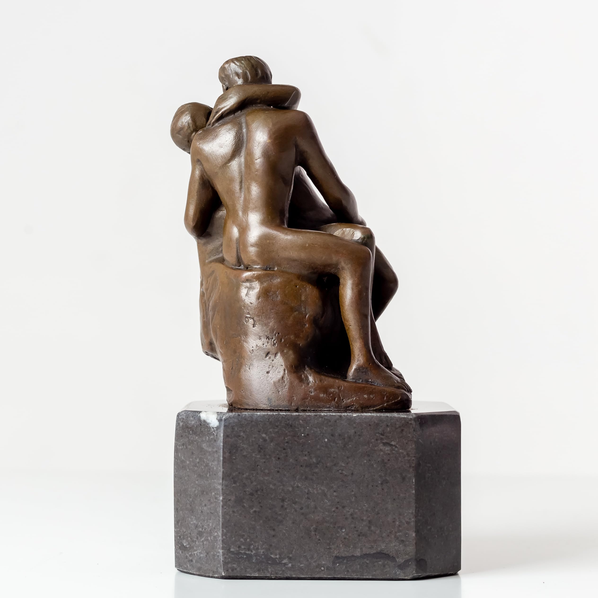 Back view of Rodin The Kiss bronze statue showing detailed sculpting of embracing lovers
