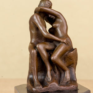 Close-up front view of Rodin The Kiss bronze statue showing detailed embrace and kiss pose