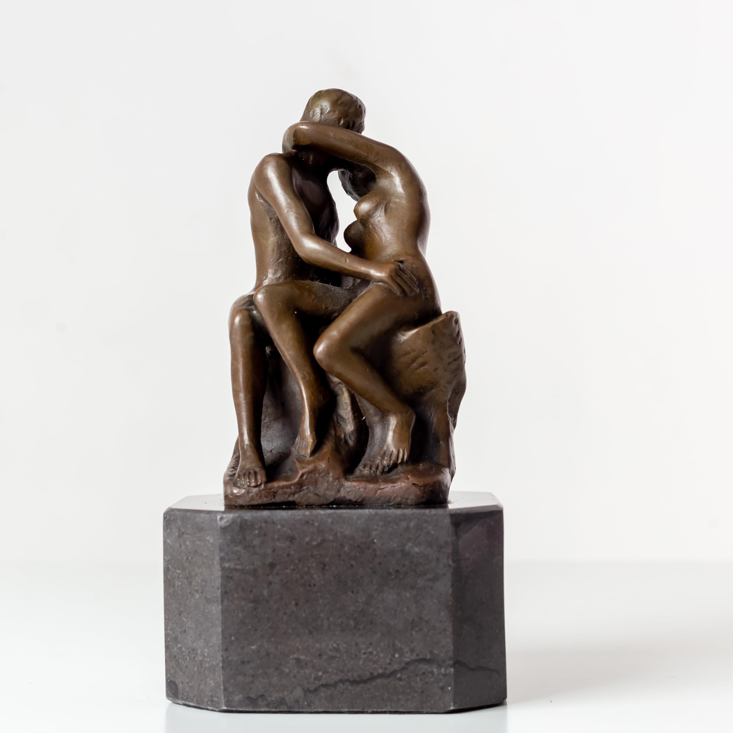 Rodin The Kiss bronze statue front view on white background, romantic lovers sculpture on marble base