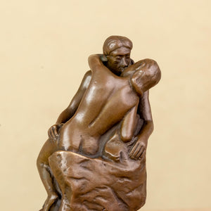 Rodin The Kiss bronze statue front view on warm beige background showing romantic couple sculpture