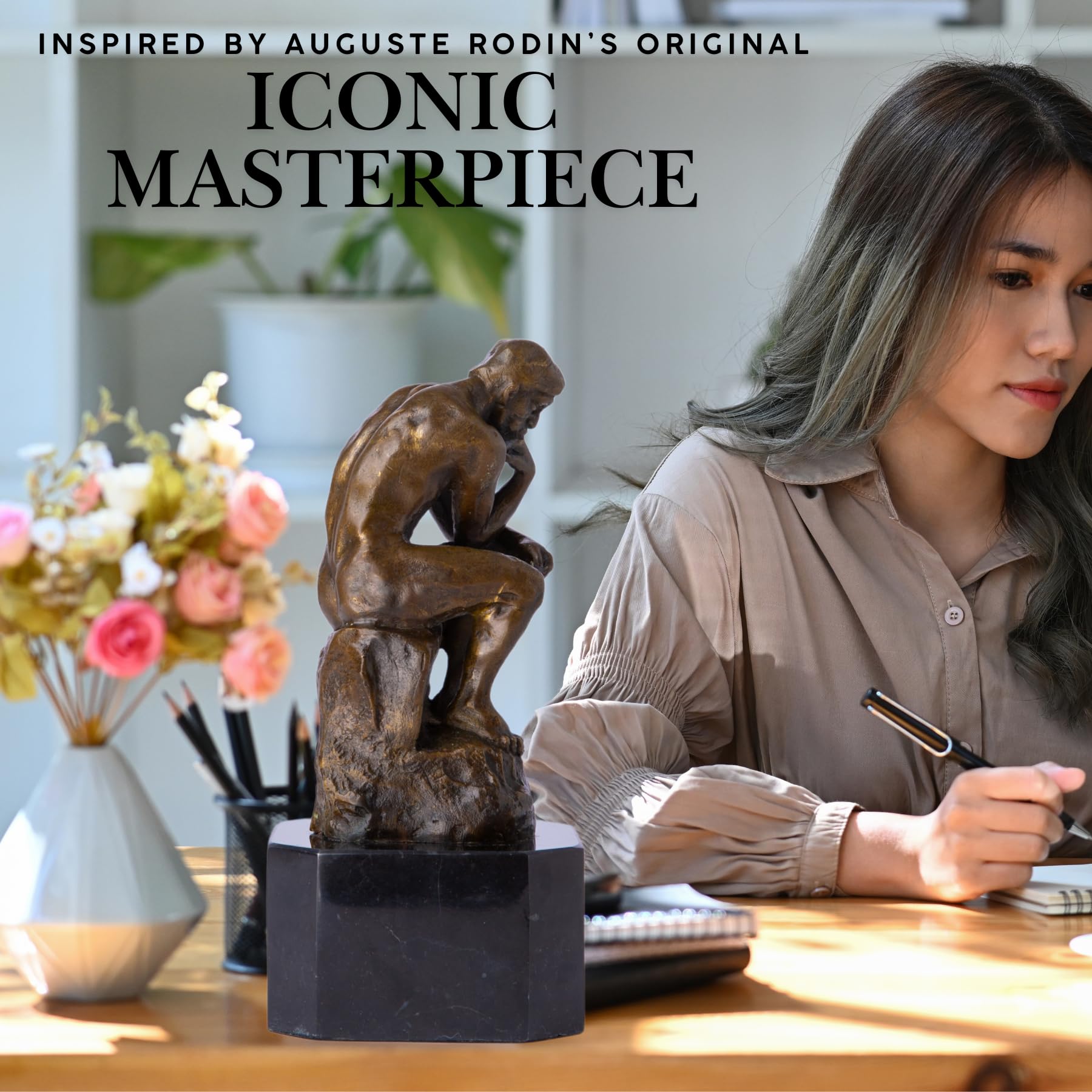 Rodin The Thinker bronze statue iconic masterpiece feature shown on desk beside woman writing