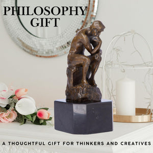 Rodin The Thinker bronze statue philosophy gift feature card beside candle and floral decor