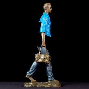Detailed view of the hand-painted sage green bag on the sky light blue bronze traveler.