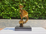 Silence is Gold abstract thinker sculpture gold finish displayed outdoors on marble base