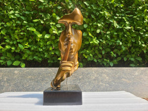 Right angle view of gold abstract thinker Silence is Gold bronze sculpture