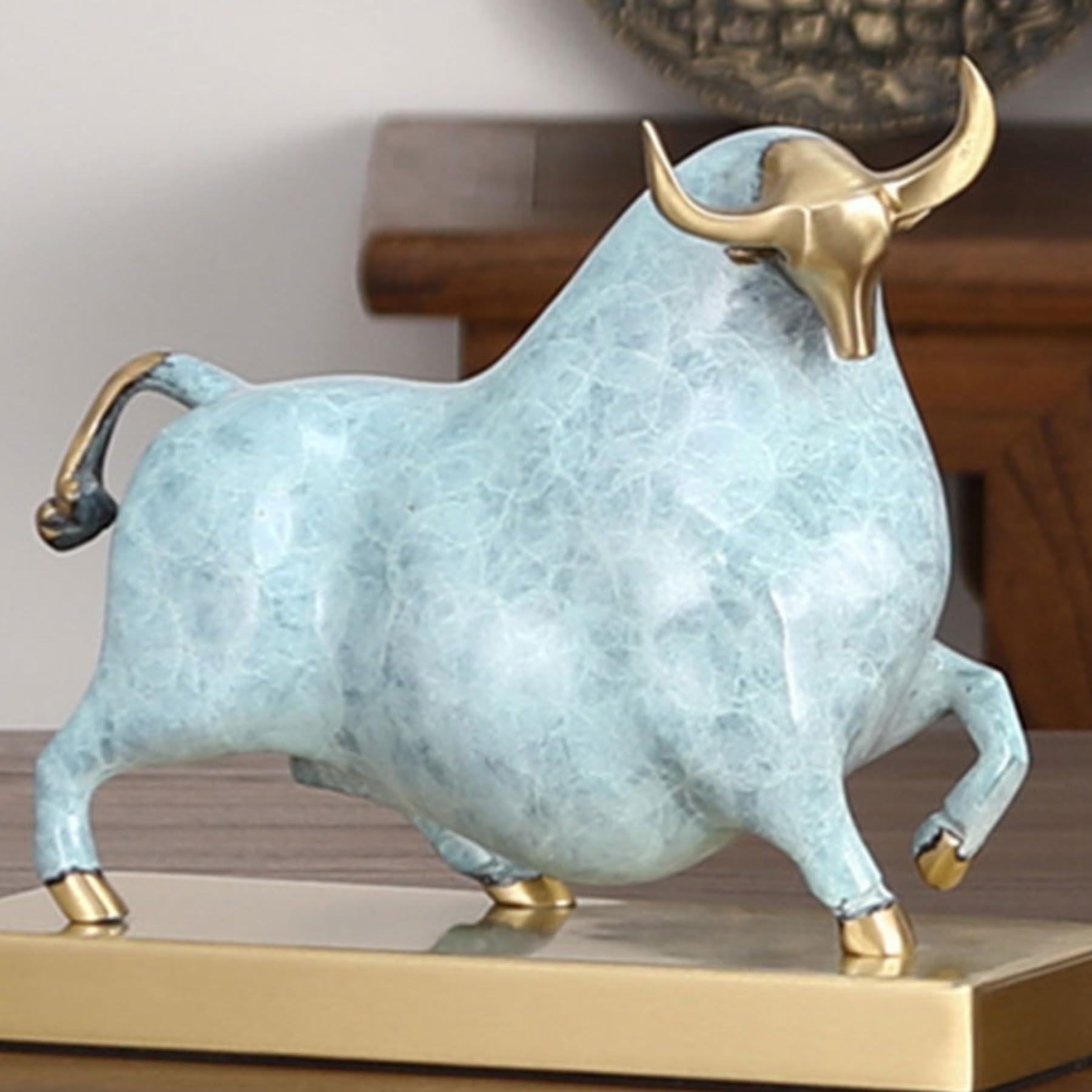 Luxury sky blue enamel bull ornament displayed on a modern office desk.